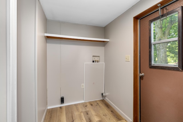 clothes washing area featuring light hardwood / wood-style flooring and hookup for a washing machine