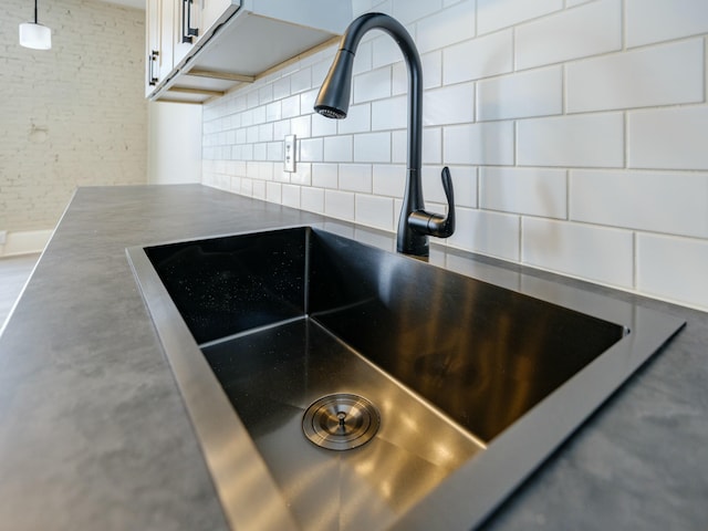 room details featuring sink and backsplash