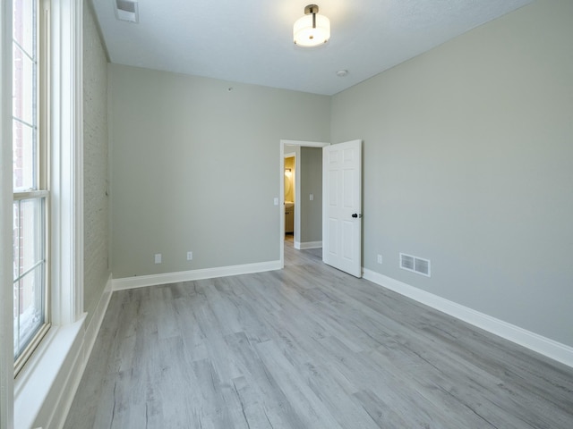 empty room with light hardwood / wood-style flooring