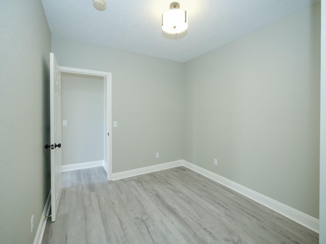 spare room with light wood-type flooring