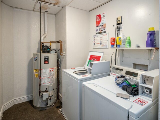 clothes washing area featuring washer and clothes dryer and gas water heater