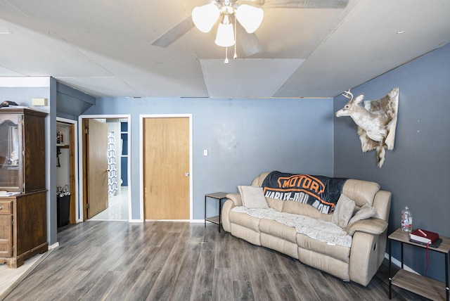 living room featuring ceiling fan and hardwood / wood-style floors