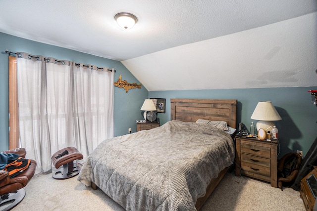 carpeted bedroom with a textured ceiling and lofted ceiling