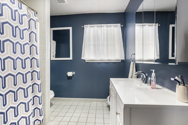 bathroom with toilet, tile patterned flooring, walk in shower, and vanity