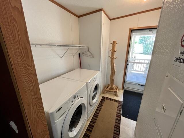 washroom featuring light tile patterned floors, independent washer and dryer, and ornamental molding