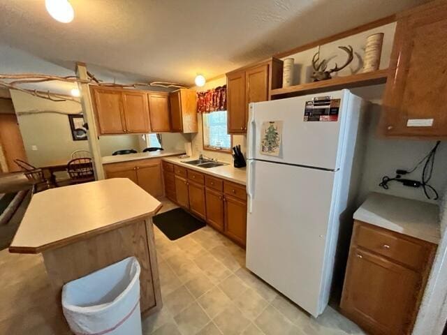 kitchen with sink and white fridge