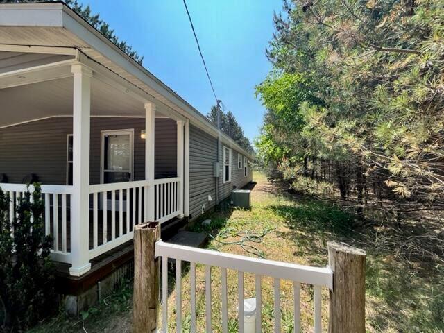 view of side of home with central AC