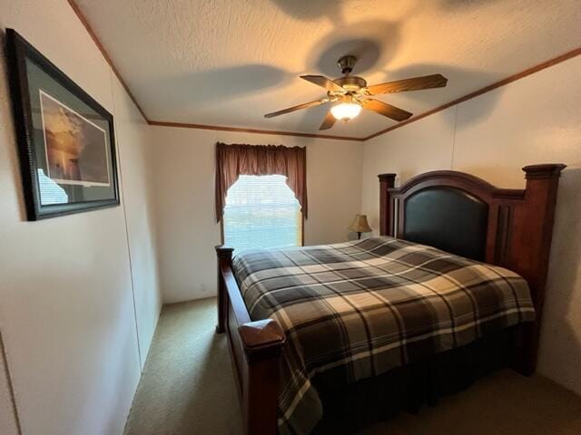 carpeted bedroom featuring ceiling fan, crown molding, and a textured ceiling