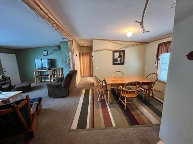 dining space featuring dark colored carpet