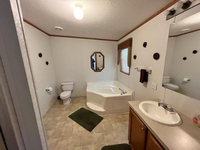 bathroom featuring toilet, a bathtub, a textured ceiling, ornamental molding, and vanity