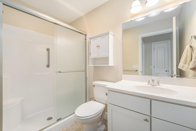 bathroom with toilet, a shower with door, and vanity