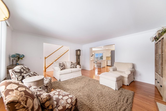 living room with ornamental molding and hardwood / wood-style floors