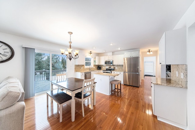 dining area featuring a chandelier and light hardwood / wood-style floors