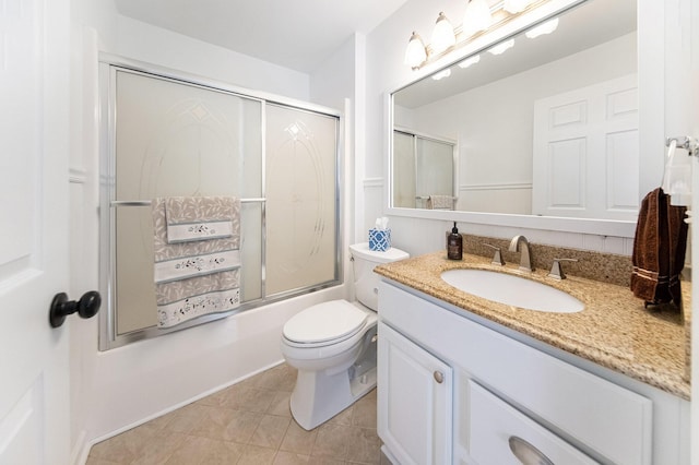 full bathroom with vanity, tile patterned floors, shower / bath combination with glass door, and toilet