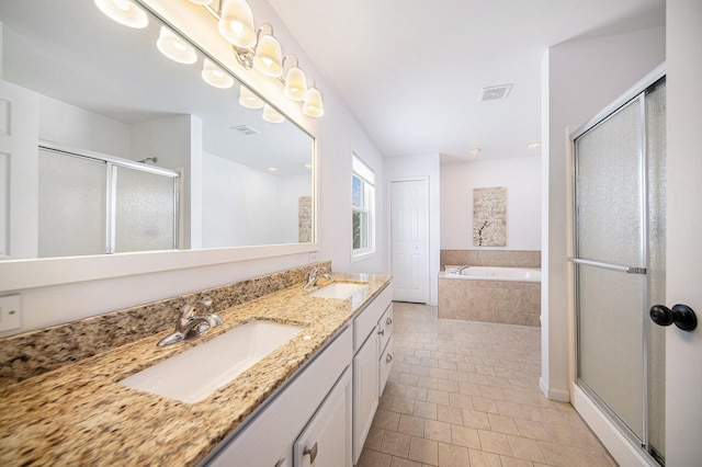 bathroom with vanity, tile patterned flooring, and plus walk in shower