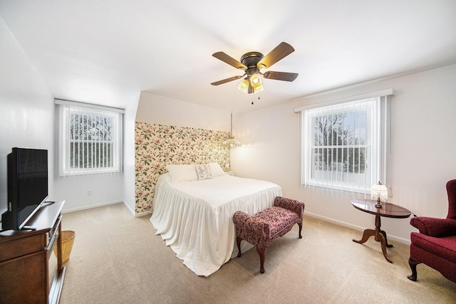 bedroom featuring light colored carpet and ceiling fan