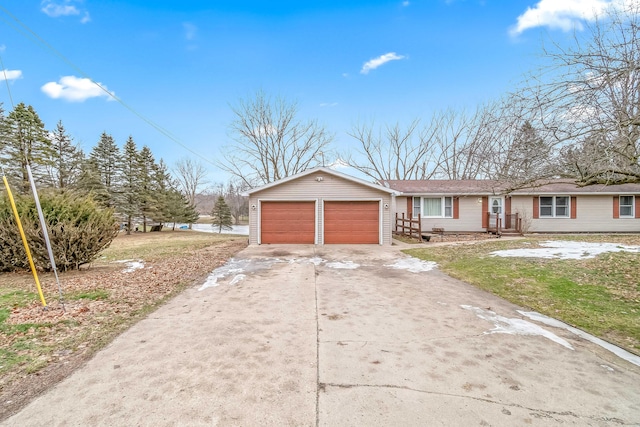 single story home featuring an outbuilding and a garage