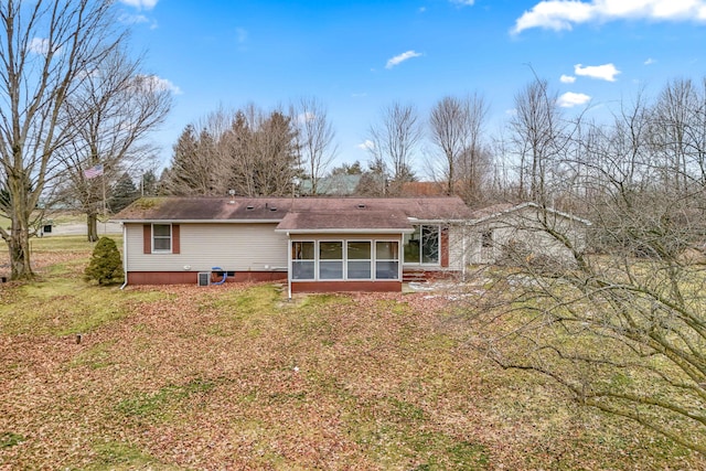 rear view of property with a sunroom