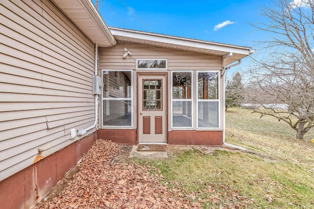 property entrance with a yard