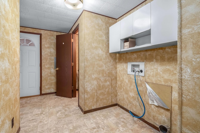 clothes washing area with cabinets and washer hookup