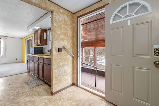 kitchen featuring plenty of natural light, sink, and light carpet