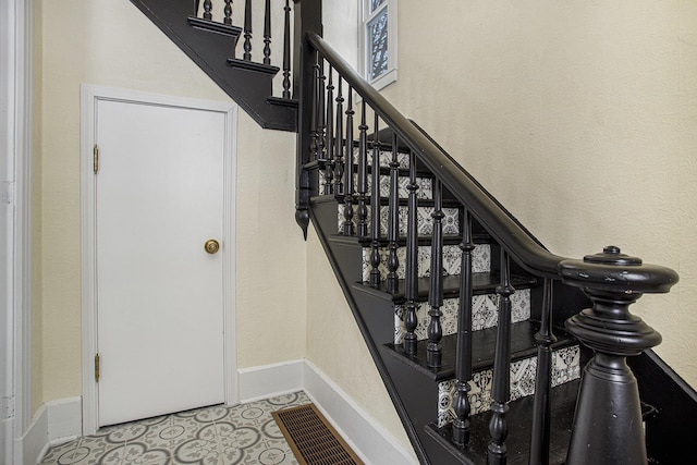 stairs featuring tile patterned flooring