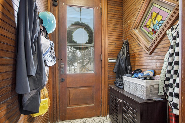 doorway to outside featuring wooden walls