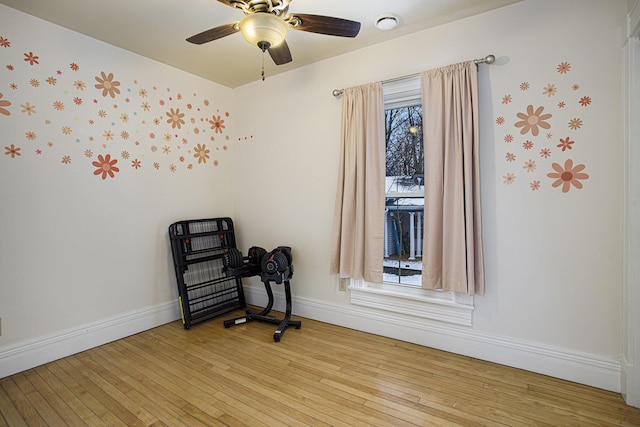 empty room with ceiling fan and light hardwood / wood-style flooring