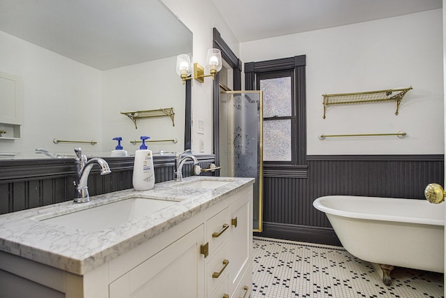 bathroom with vanity, a bathing tub, and a notable chandelier