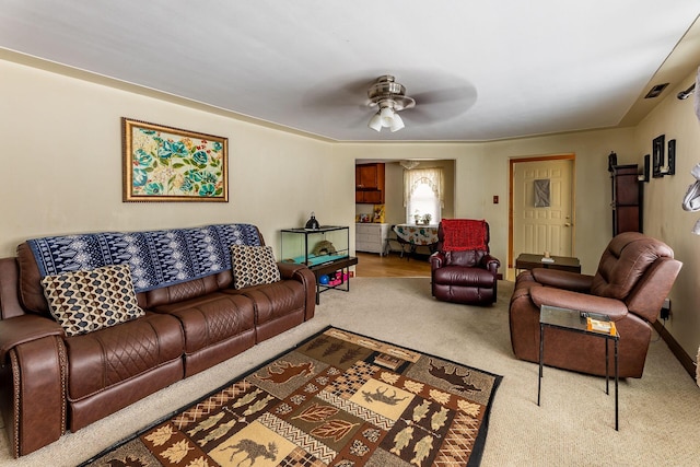 living room featuring ceiling fan and carpet