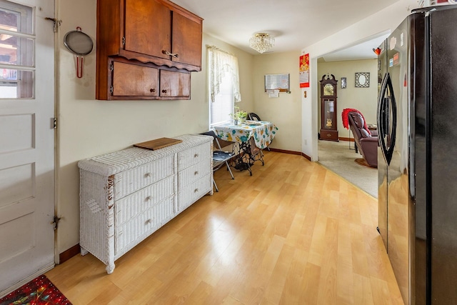 kitchen featuring black fridge and light wood-type flooring