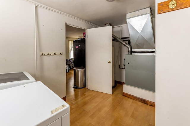 laundry room featuring light hardwood / wood-style flooring and washer / dryer