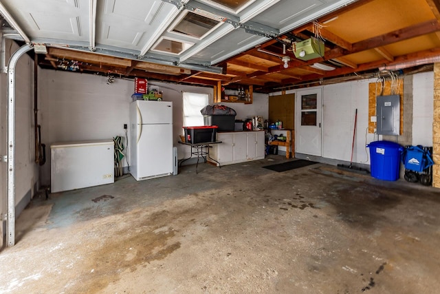 garage with fridge, electric panel, white refrigerator, and a garage door opener