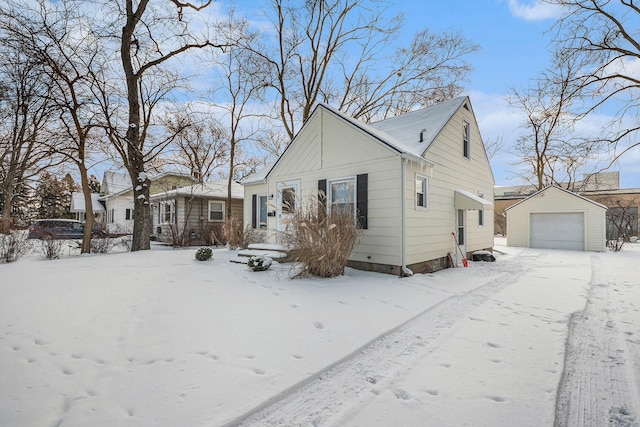 view of front of house featuring a garage and an outbuilding