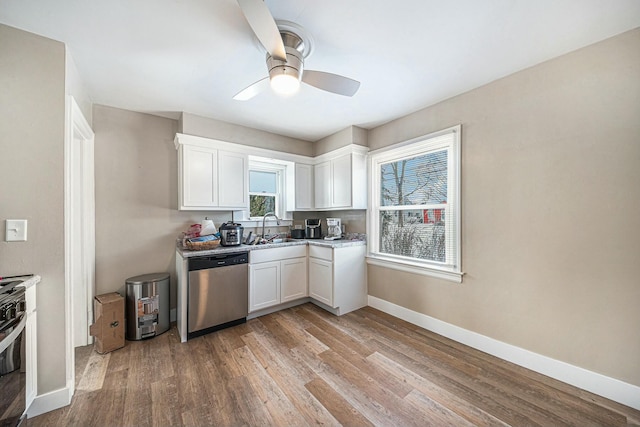 kitchen with ceiling fan, dishwasher, sink, white cabinetry, and light hardwood / wood-style flooring