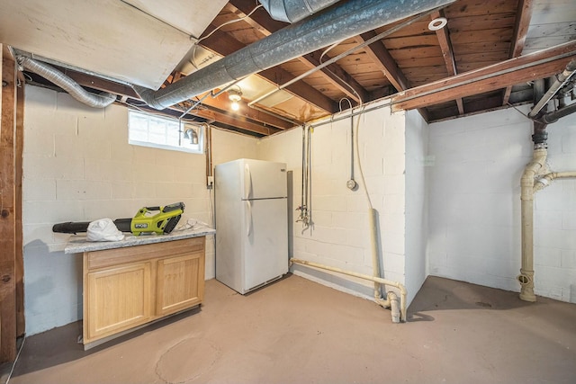 basement featuring white refrigerator