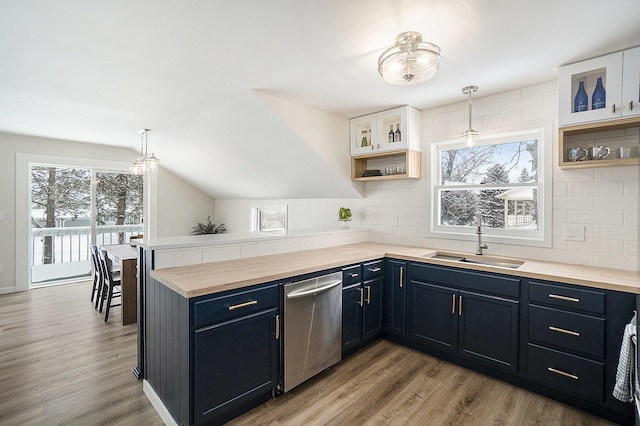 kitchen with white cabinets, decorative light fixtures, sink, plenty of natural light, and stainless steel dishwasher