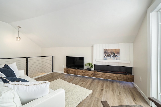 living room featuring hardwood / wood-style floors and vaulted ceiling