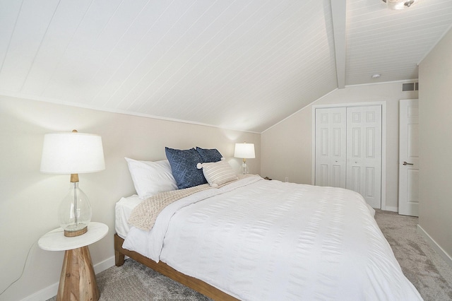 carpeted bedroom with a closet and vaulted ceiling