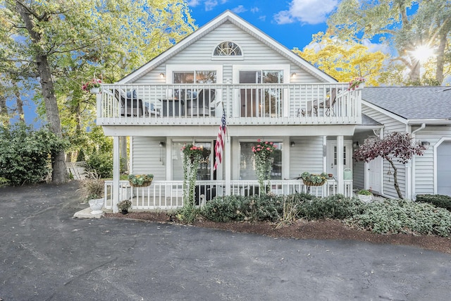 view of front of house featuring a balcony and covered porch