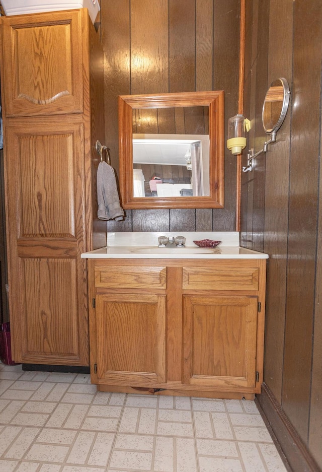 bathroom with vanity and wood walls