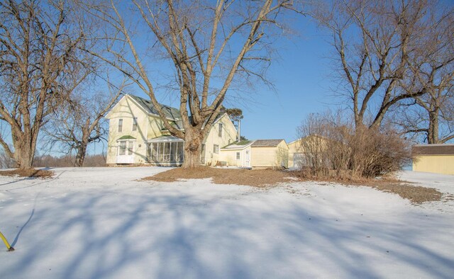 view of front of house featuring a storage unit