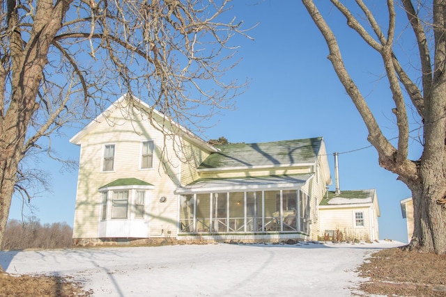 view of front facade with a sunroom