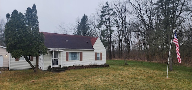 view of home's exterior featuring a garage and a yard