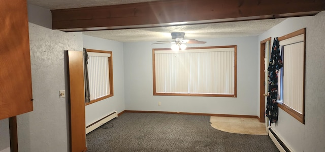 empty room featuring ceiling fan, baseboard heating, a textured ceiling, and carpet flooring