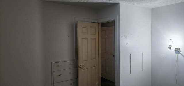 hallway featuring a textured ceiling