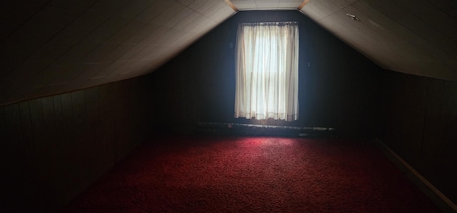 bonus room with carpet and vaulted ceiling