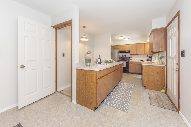 kitchen featuring electric range oven, sink, hanging light fixtures, stainless steel fridge, and range hood