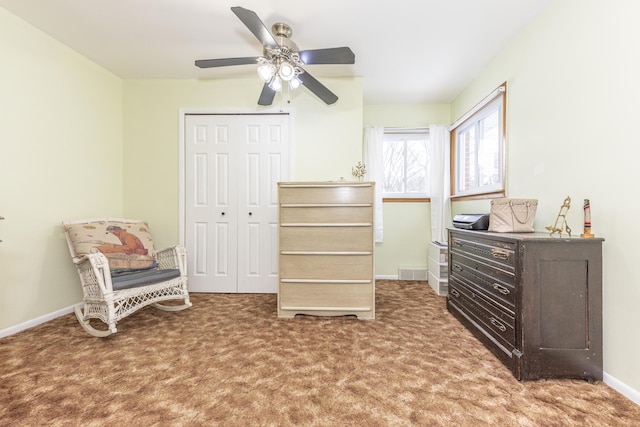 sitting room with ceiling fan and carpet flooring