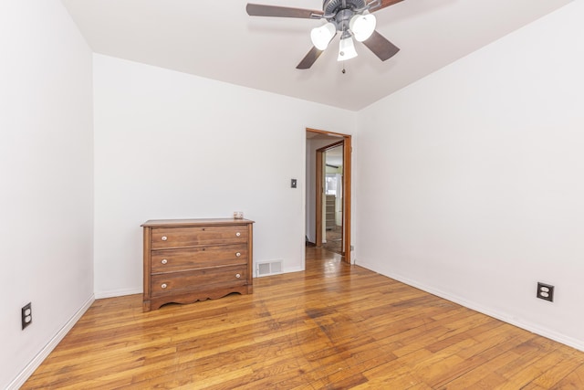 empty room featuring ceiling fan and light hardwood / wood-style floors